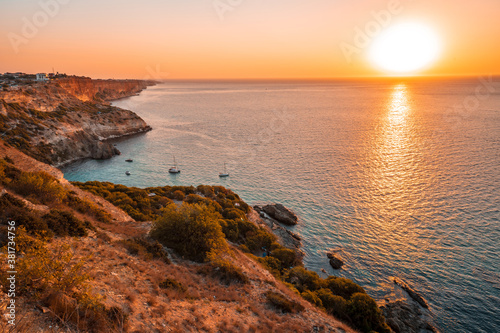 Sunset on Cape Fiolent, panorama of the black sea with azure water, Crimea