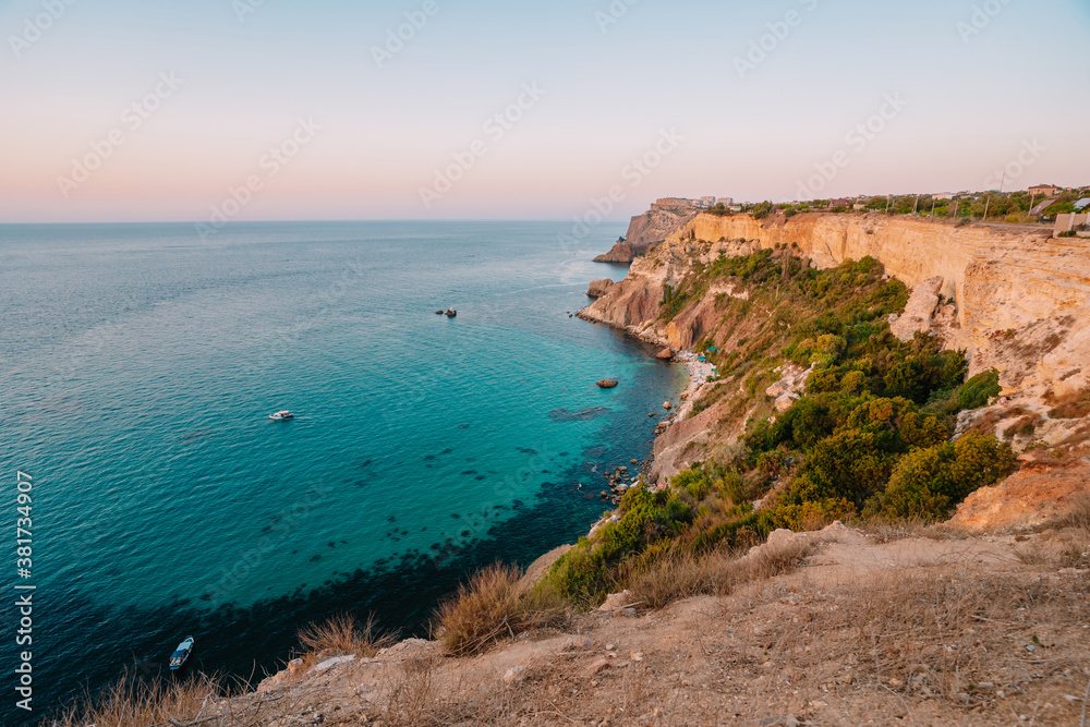 Sunset on Cape Fiolent, panorama of the black sea with azure water, Crimea