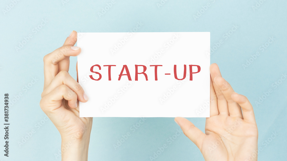 Fototapeta premium businessman hand showing poster of start up icon as concept