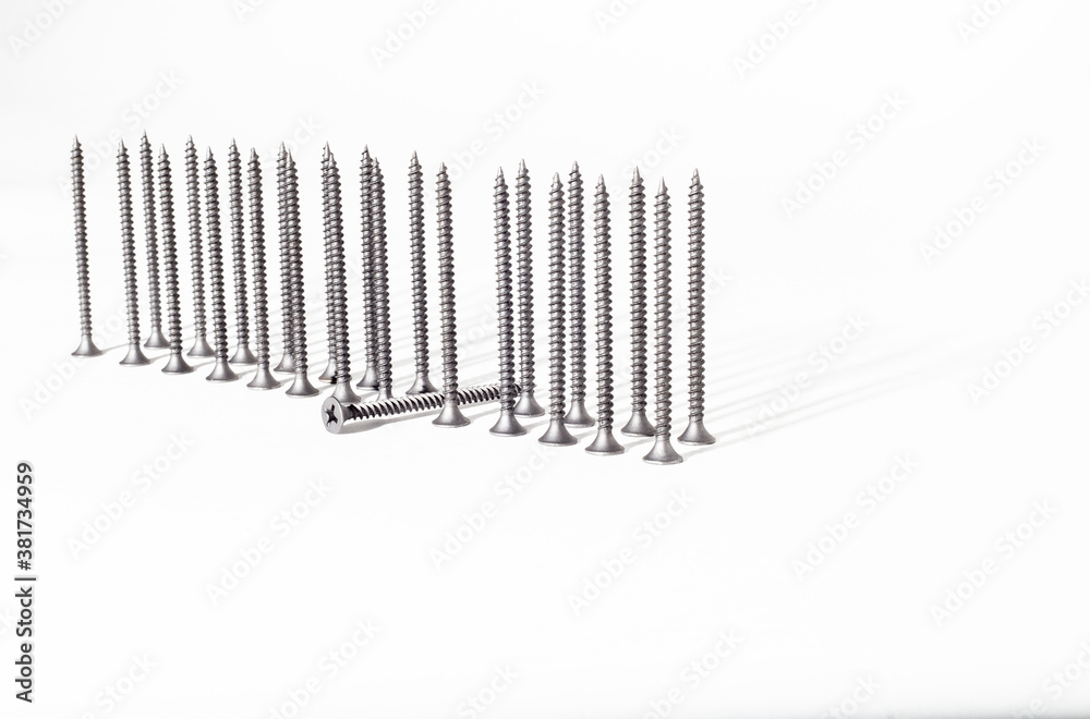 Screw on a white background close-up. Self-tapping screw in golden yellow color for wood, chipboard or plywood with a large head. Screw on a white background close-up. Self-tapping screw in golden yellow color for wood, chipboard or plywood with a large head.