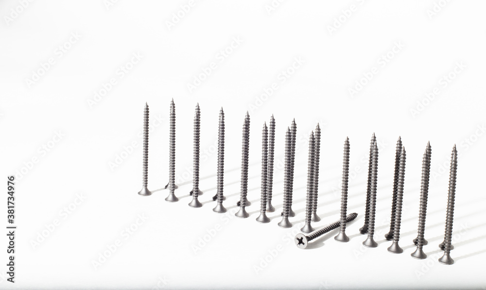 Screw on a white background close-up. Self-tapping screw in golden yellow color for wood, chipboard or plywood with a large head. Screw on a white background close-up. Self-tapping screw in golden yellow color for wood, chipboard or plywood with a large head.