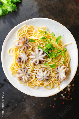 spaghetti pasta baby octopus seafood warm salsd fresh second course on the table tasty serving size top view copy space for text food background rustic