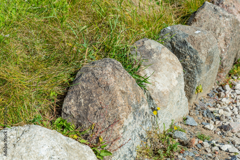 Untreated rough natural stone in everyday environment, gardening and landscaping Untreated rough natural stone in everyday environment, gardening and landscaping