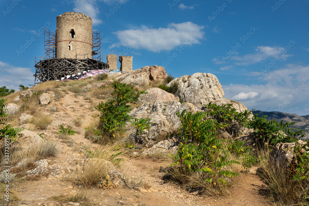 This is the Barnabo Grillo tower and ruined wall of Chembalo fortress during the reconstruction. Crimean medieval architecture landmark. Ruined Genoese fortress in Balaklava near Sevastopol, Crimea.
