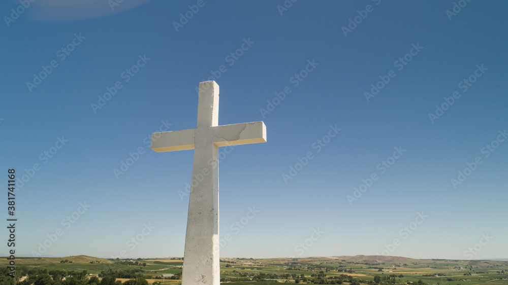 White cross on the top of a hill