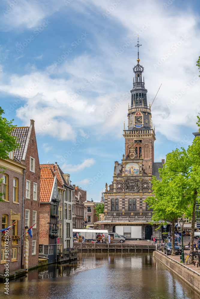 Fototapeta premium Alkmaar, The Netherlands - April 26, 2019. Street view of Alkmaar city in the province of North Holland. Old traditional Dutch houses.