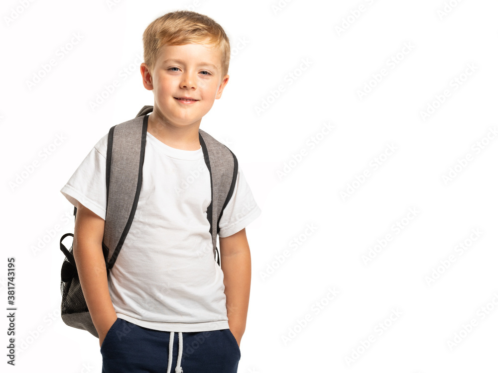 Smiling boy standing with backpack on white background Smiling boy standing with backpack on white background