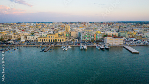 Obraz na plátně Beautiful panoramic aerial view photo from flying drone on Molfetta waterfront with the Old Cathedral San Corrado (Duomo Vecchio),port with ships and yachtsand the Molfetta city sunset