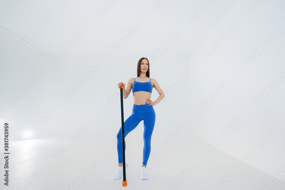 Sexy young girl performs sports exercises on a white background. Fitness, healthy lifestyle Sexy young girl performs sports exercises on a white background. Fitness, healthy lifestyle