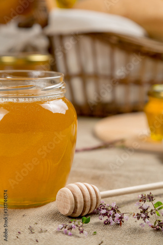 Linden honey in a glass jar with rustic decor