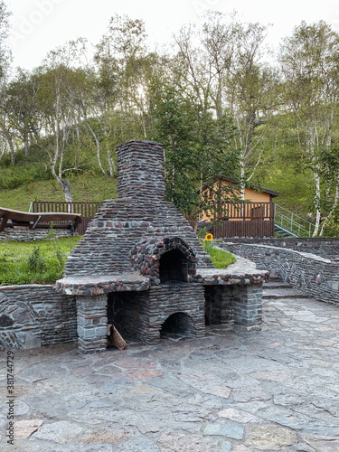 Stone oven in the open air with green foliage for a country holiday