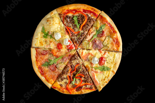 Assorted several types of pizza. Black background.