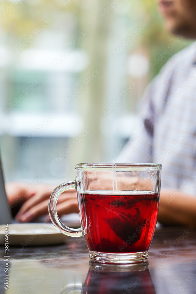 Businessman sitting in cafe, drinking healthy tea and using laptop Businessman sitting in cafe, drinking healthy tea and using laptop