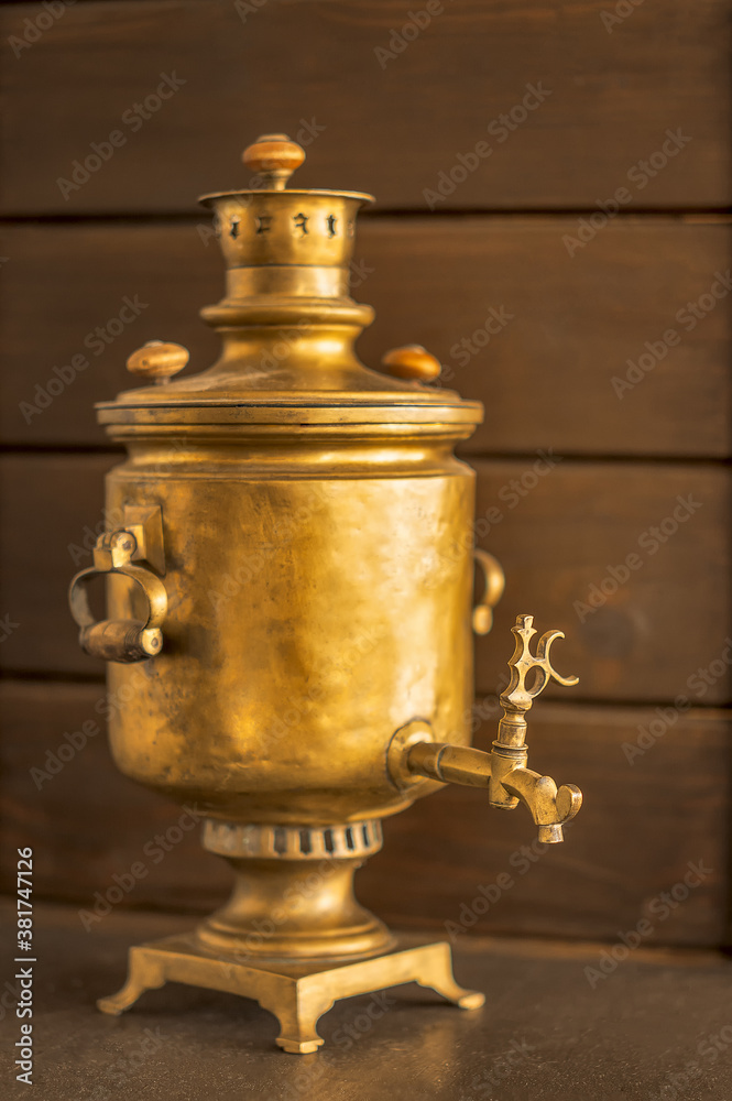 Russian brass antique samovar on a wooden background.