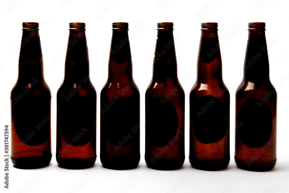 empty beer bottles all in a row isolated on white empty beer bottles all in a row isolated on white