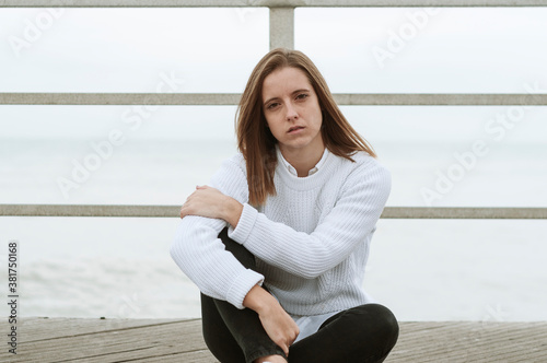 Free Download Young girl photographed on the beach on a rainy autumn day - GFXLoad