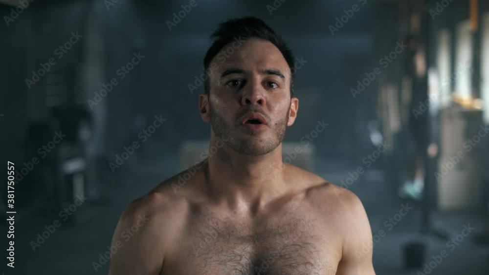 portrait of a muscular tired man looking at the camera with shortness of breath after hard training. 4K slow motion portrait of a muscular tired man looking at the camera with shortness of breath after hard training. 4K slow motion