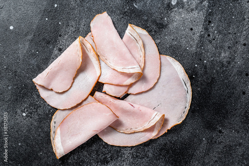 Slices of pork pastrami. Organic meat. Black background. Top view