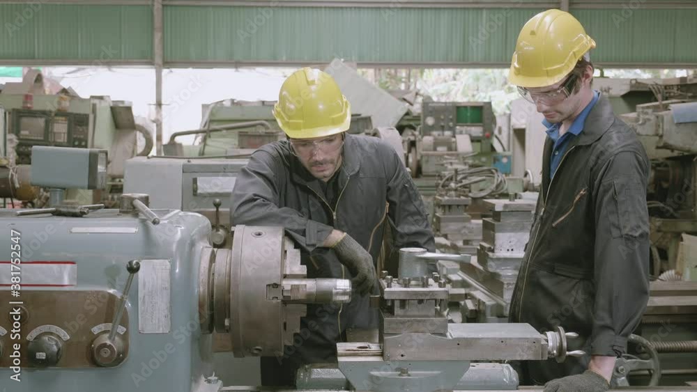 Engineer man training with foreman for apprentice using lathe, apprenticeship teaching with worker, technician and learning, inspector and labor, internship and workshop, industrial concept.