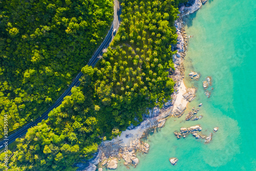 High angle view of road pass through coconut tree forest and beautiful coastline in Khanom, Nakhon si thammarat, Thailand.