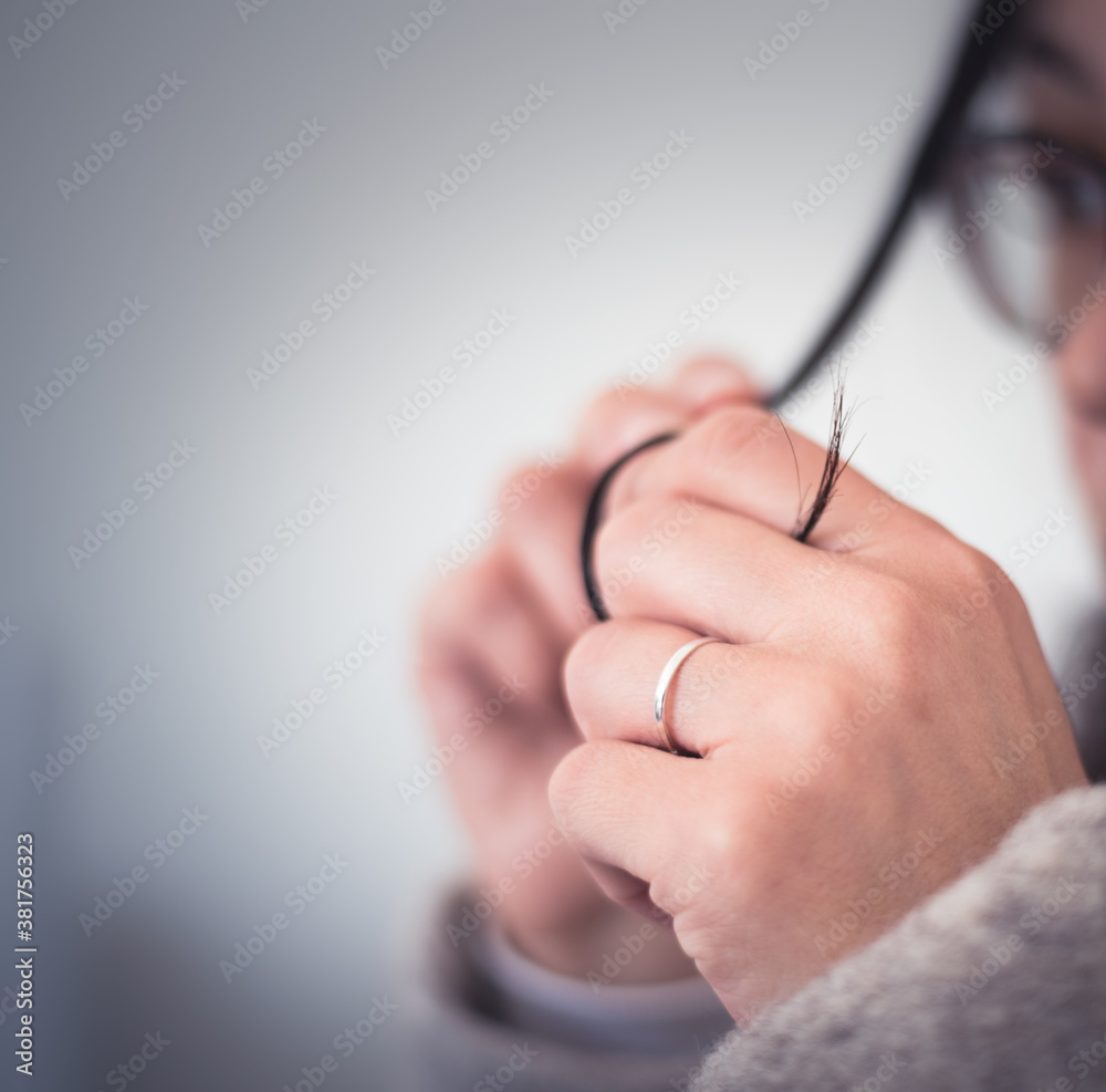 Great concept of divorce, ending of relationship, young woman pulling wedding ring from finger. Soft blurred concept. Great concept of divorce, ending of relationship, young woman pulling wedding ring from finger. Soft blurred concept.