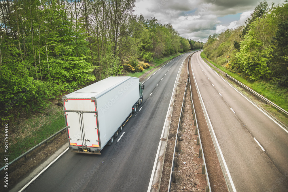 A truck on a dual carriageway - no cars on motorway but one lorry - obrazy, fototapety, plakaty 