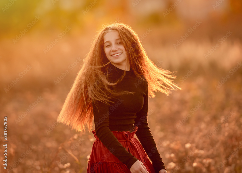 Smiling teenage girl on autumn field Smiling teenage girl on autumn field
