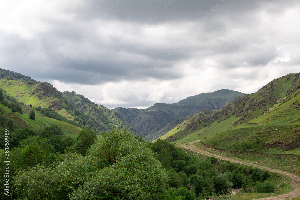 Obraz premium Mountain landscape with blue sky. Panoramic view of green hills. 