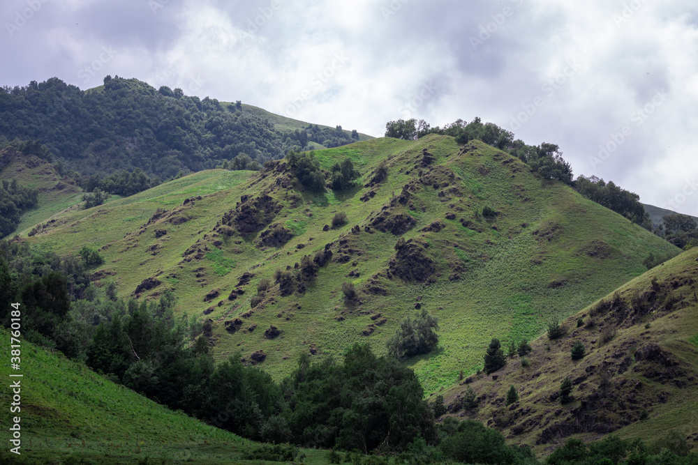 Obraz premium Mountain landscape with blue sky. Panoramic view of green hills.