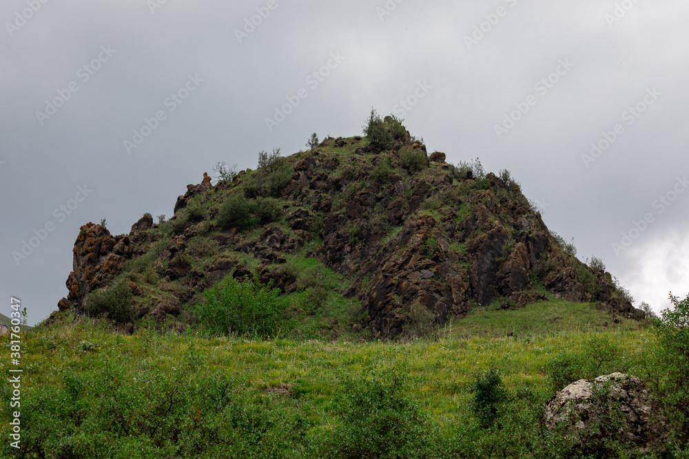 Mountain landscape with blue sky. Panoramic view of green hills.