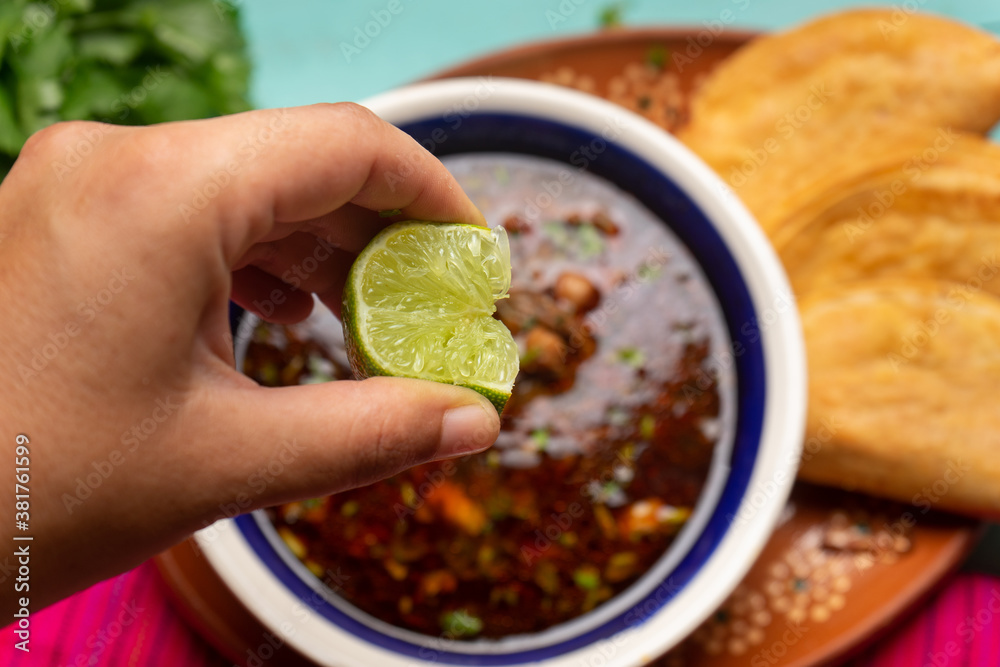 Mexican birria consome soup and tacos on turquoise background Stock Photo Adobe Stock