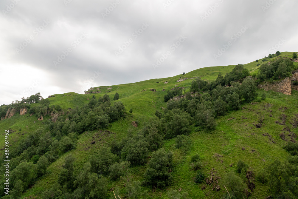 Mountain landscape with blue sky. Panoramic view of green hills. Mountain landscape with blue sky. Panoramic view of green hills.