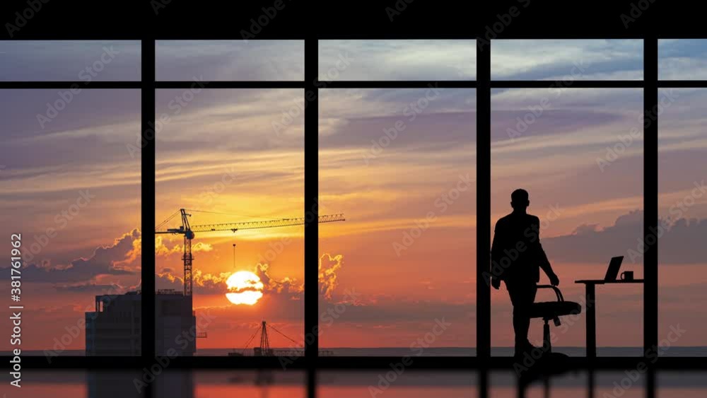 The businessman working in the office on the big building background. time lapse The businessman working in the office on the big building background. time lapse