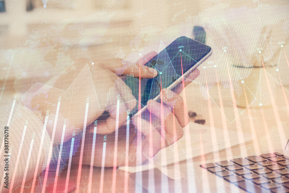 Double exposure of man's hands holding and using a digital device and forex graph drawing. Financial market concept. Double exposure of man's hands holding and using a digital device and forex graph drawing. Financial market concept.