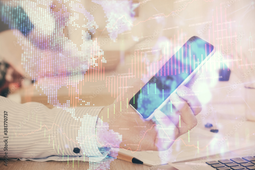 Double exposure of man's hands holding and using a digital device and forex graph drawing. Financial market concept. Double exposure of man's hands holding and using a digital device and forex graph drawing. Financial market concept.