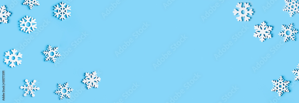 Cerulean colour year 2021.Blue Christmas background with white wodden snowflakes. Flat lay banner, poster with copy space. New year, winter mood. Mickup. Greeting card, header, website. Minimal Cerulean colour year 2021.Blue Christmas background with white wodden snowflakes. Flat lay banner, poster with copy space. New year, winter mood. Mickup. Greeting card, header, website. Minimal