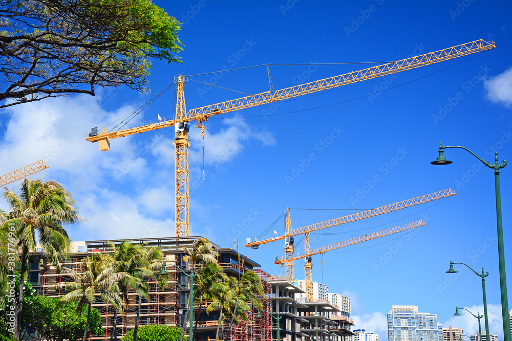 New condo buildings under construction with cranes along Ala Moana Blvd in Honolulu on Oahu, Hawaii. New condo buildings under construction with cranes along Ala Moana Blvd in Honolulu on Oahu, Hawaii.