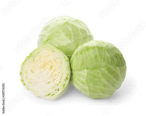 Whole and cut fresh ripe cabbages on white background