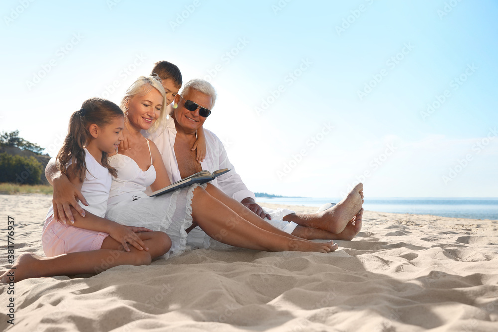 Cute little children with grandparents spending time together on sea beach