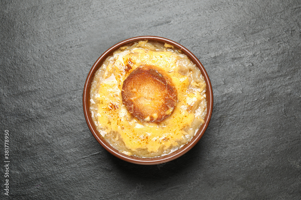Tasty homemade french onion soup on black table, top view Tasty homemade french onion soup on black table, top view