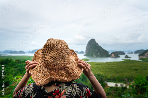 Travel and holiday concept photo, close-up at back of traveler's hat with blurred background of 