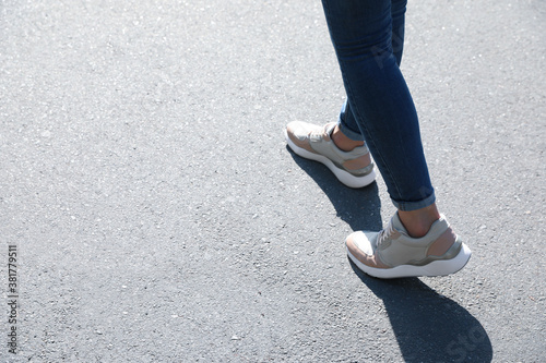 Woman walking outdoors, closeup with space for text. Choosing way concept.