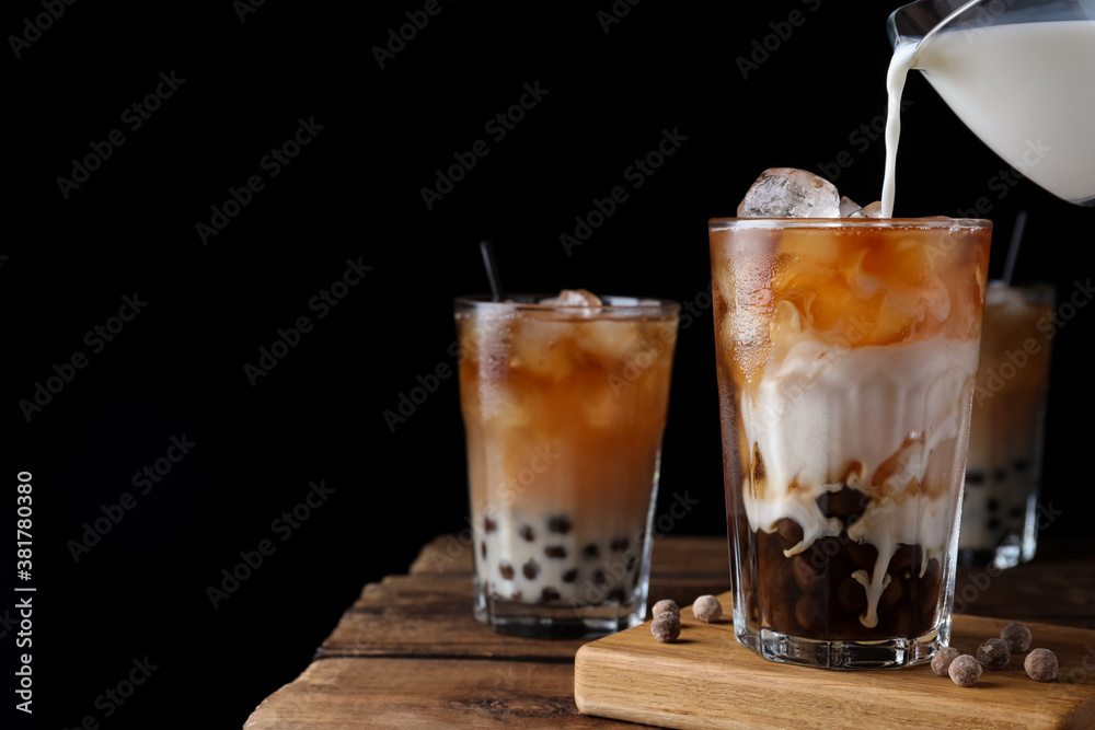 Making tasty milk bubble tea on wooden table. Space for text Making tasty milk bubble tea on wooden table. Space for text