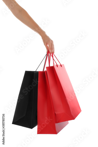 Woman with paper shopping bags on white background, closeup