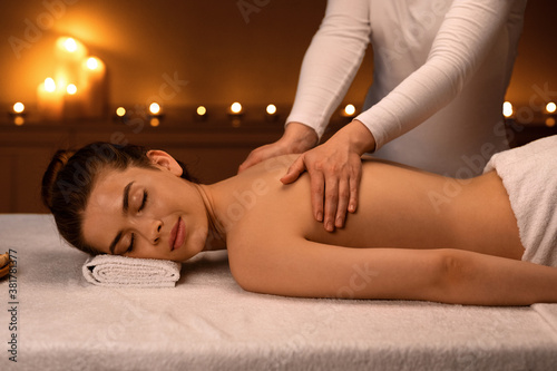Woman having body massage session at modern spa