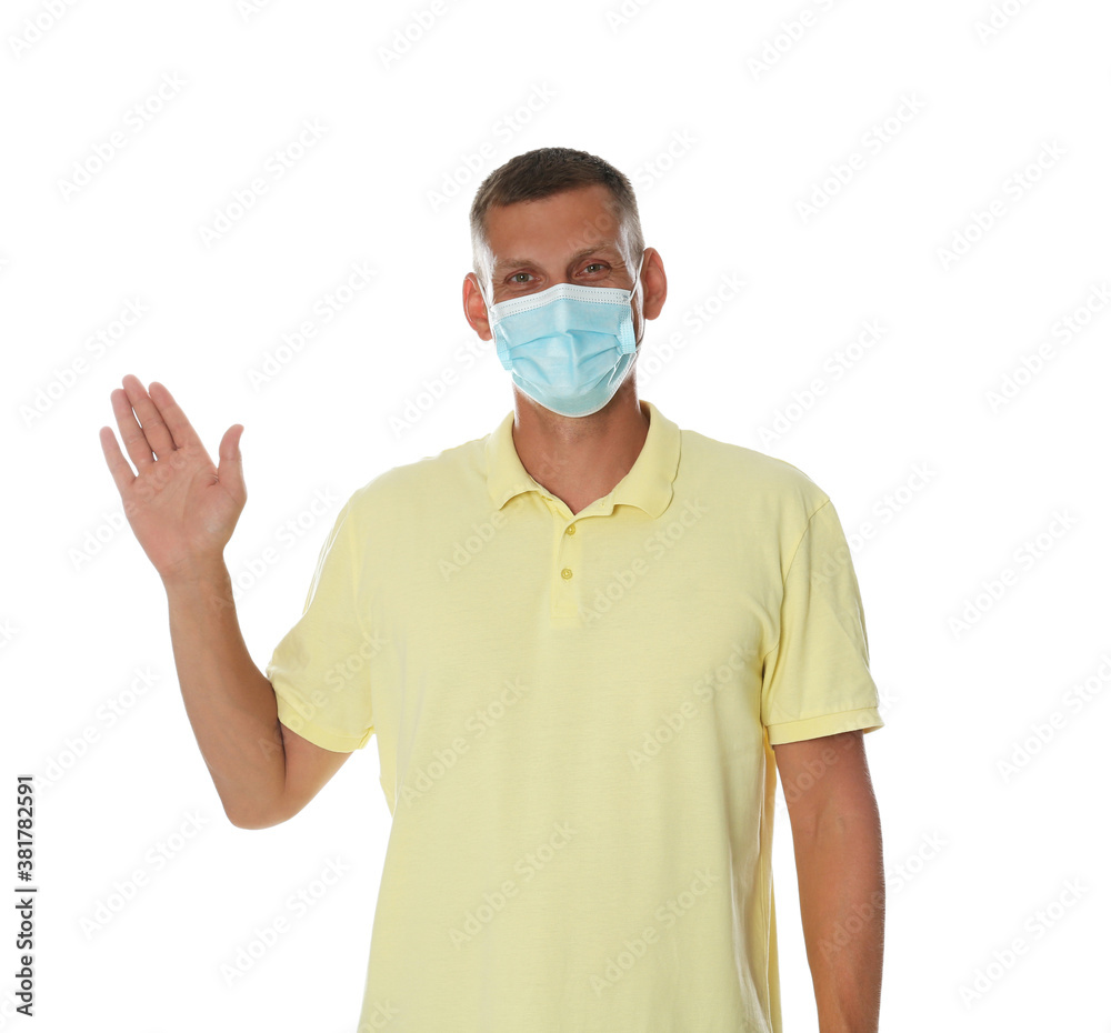 Man in protective mask showing hello gesture on white background. Keeping social distance during coronavirus pandemic Man in protective mask showing hello gesture on white background. Keeping social distance during coronavirus pandemic