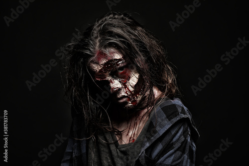 Scary zombie on dark background. Halloween monster