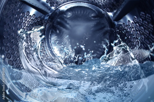Obraz na plátně Washing machine drum with water, closeup view