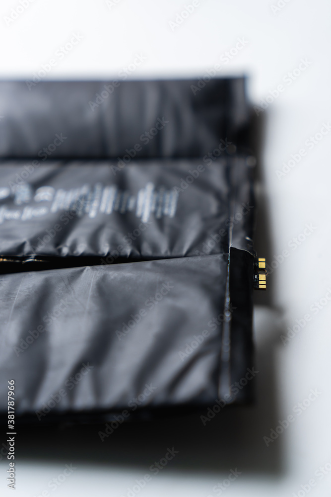 Battery is swollen, expiry battery on white background. Li-polymer ...