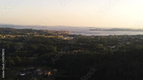 Landscape and a large green forest , Aerial view of a small village Arano , Navarre , Spain , Zoom out photo